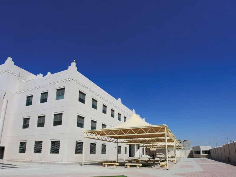 Completed school building exterior under blue sky